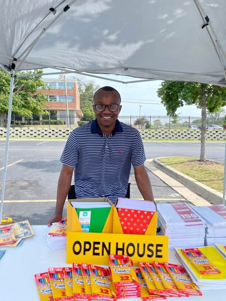Krishon at his booth at a back-to-school fair with school supplies