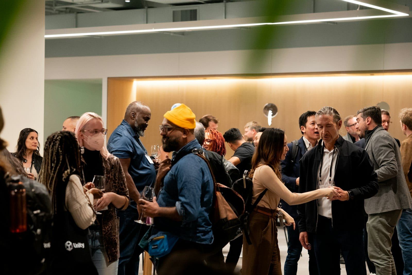 A crowd of professionals mingling at an indoor event