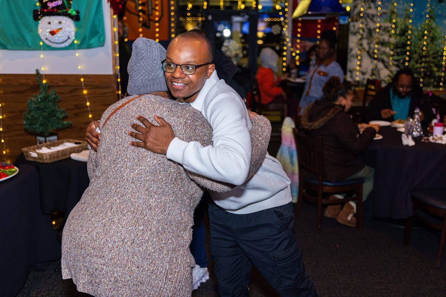 Krishon hugging a guest at a client appreciation event