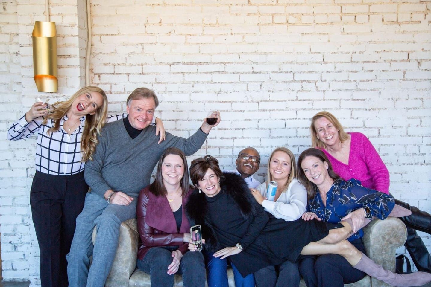 Krishon and agents from his office laughing together on a couch